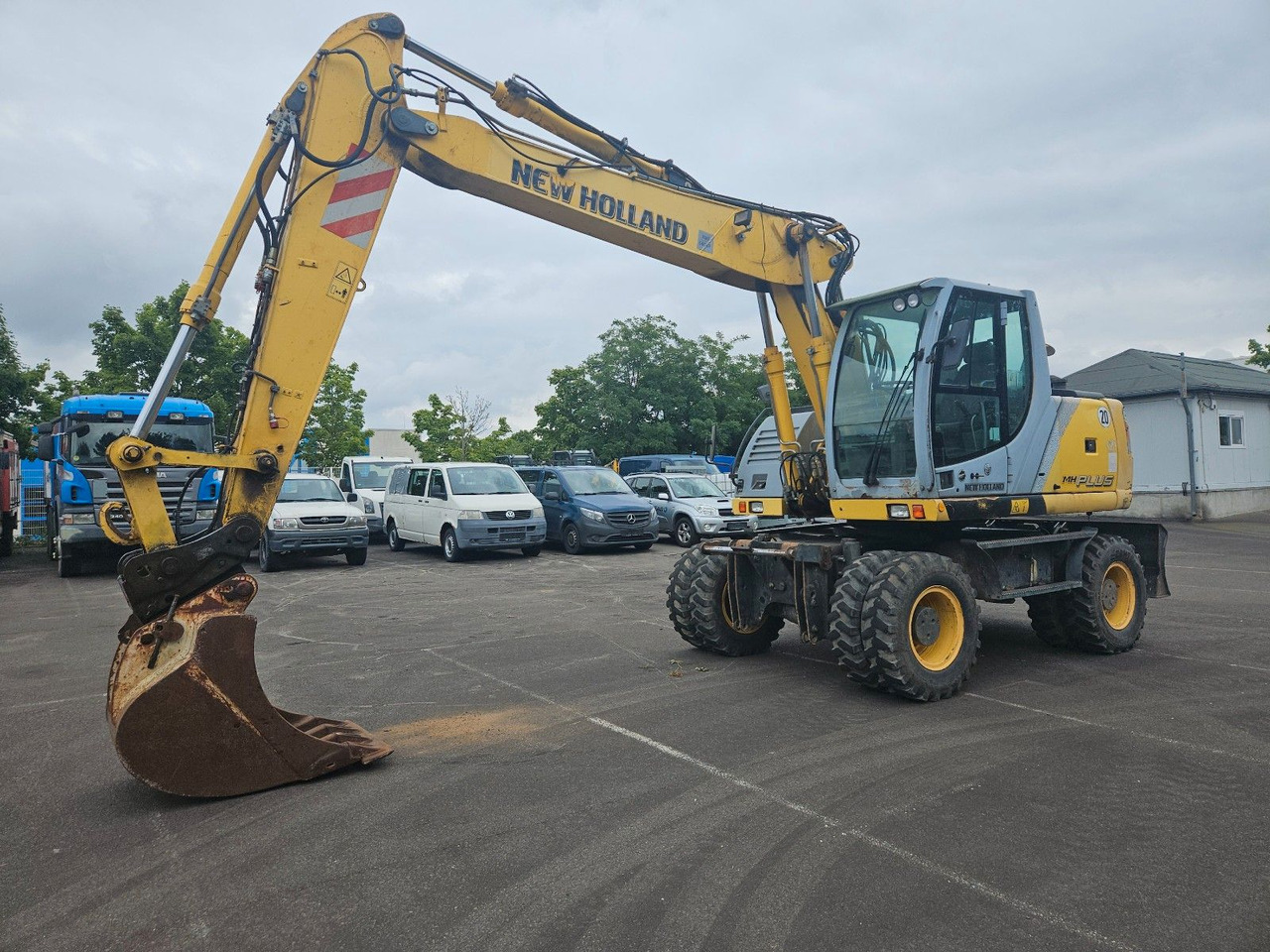New Holland MH Plus 18t Mobilbagger - Máy xúc bánh lốp: hình 1 New Holland MH Plus 18t Mobilbagger - Máy xúc bánh lốp: hình 1
