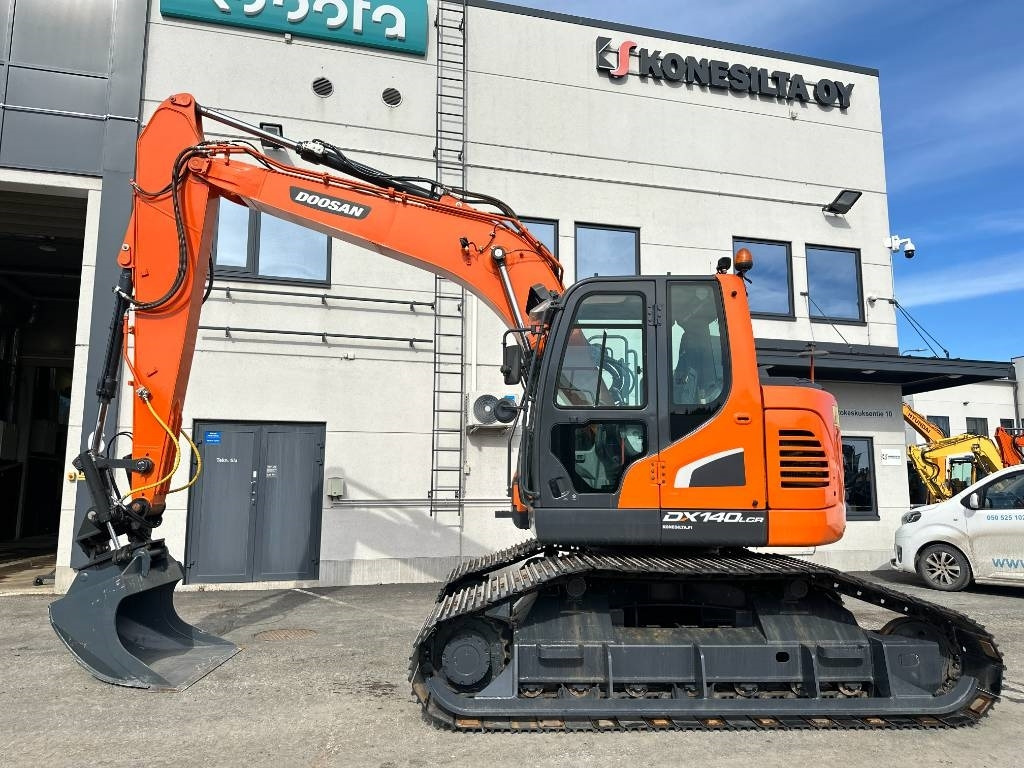 Doosan DX 140 LCR-5 metsäalusta - Máy xúc bánh xích: hình 1 Doosan DX 140 LCR-5 metsäalusta - Máy xúc bánh xích: hình 1