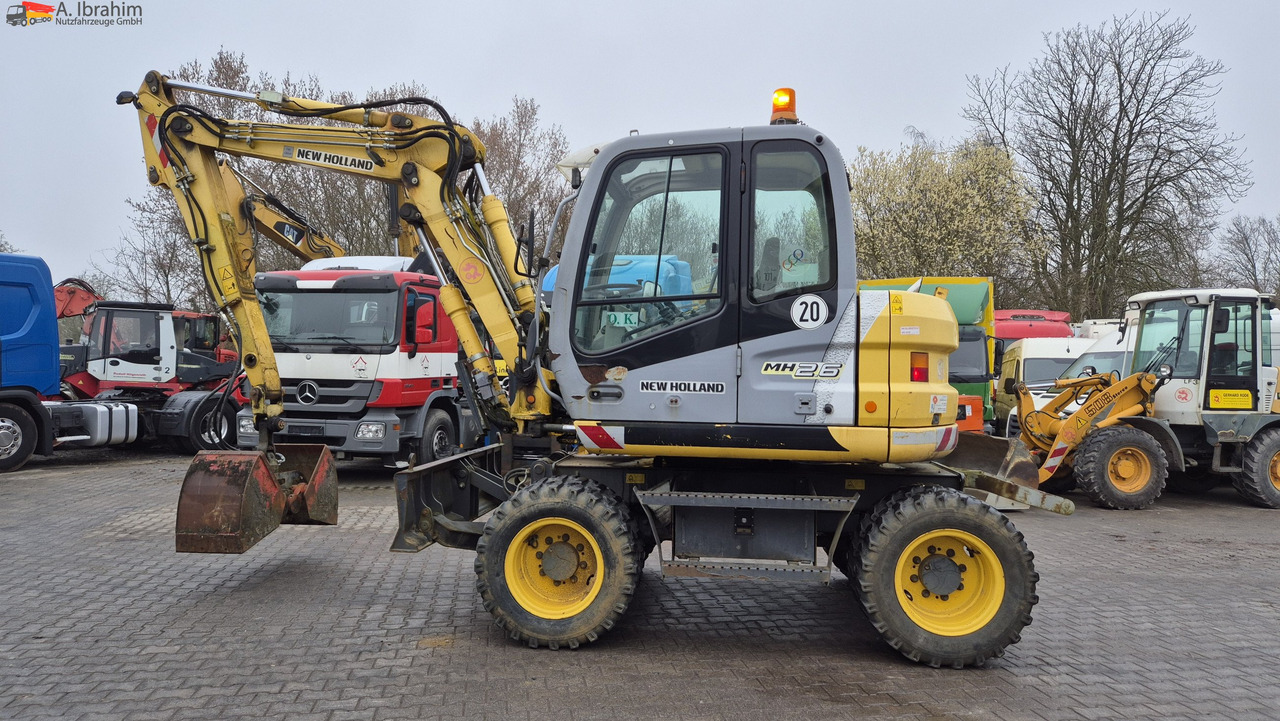 New Holland MH 2.6 Zustand gut, deutsche Maschine incl. Greifer und Dreservo - Máy xúc bánh lốp: hình 1 New Holland MH 2.6 Zustand gut, deutsche Maschine incl. Greifer und Dreservo - Máy xúc bánh lốp: hình 1