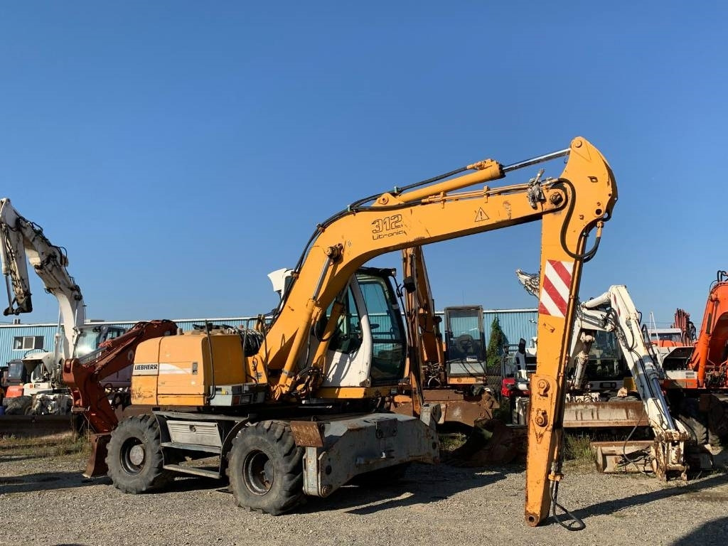 Liebherr A 312 - Máy xúc bánh lốp: hình 5 Liebherr A 312 - Máy xúc bánh lốp: hình 5