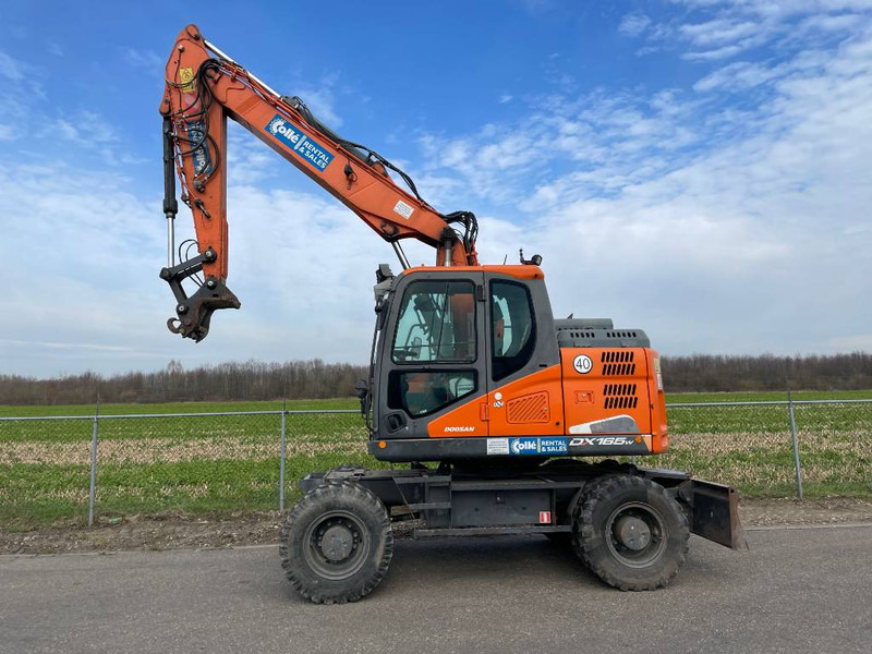 Doosan DX165W-5 - Máy xúc bánh lốp: hình 1 Doosan DX165W-5 - Máy xúc bánh lốp: hình 1