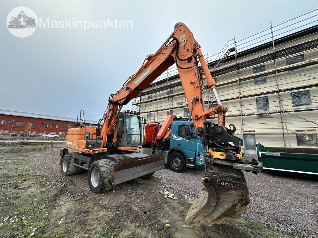 Doosan DX 140 W med vagn och redskap  - Máy xúc bánh lốp: hình 2 Doosan DX 140 W med vagn och redskap  - Máy xúc bánh lốp: hình 2