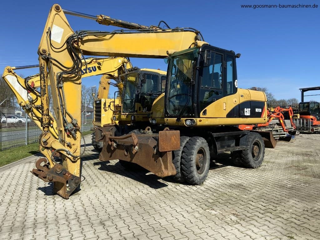 CAT M 315 D - Máy xúc bánh lốp: hình 1 CAT M 315 D - Máy xúc bánh lốp: hình 1